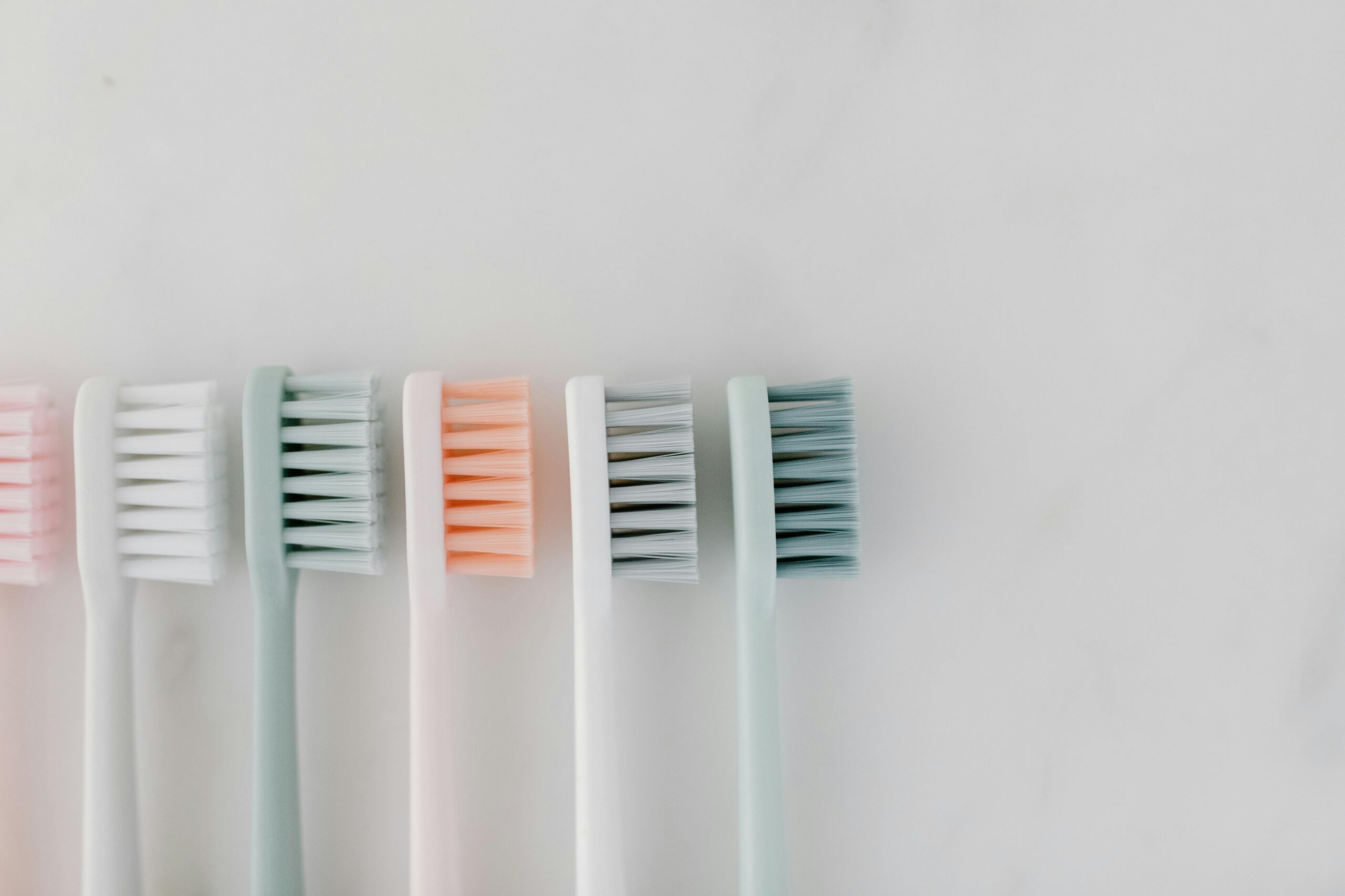 color toothbrushes in a row